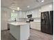 Newly renovated kitchen with white cabinets, stainless steel appliances, and an island at 604 Ponderosa Dr, St Cloud, FL 34769