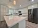 Bright, updated kitchen featuring stainless steel appliances, island, and herringbone backsplash at 604 Ponderosa Dr, St Cloud, FL 34769