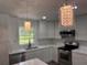 Bright kitchen with modern pendant lighting, herringbone backsplash, and stainless appliances at 604 Ponderosa Dr, St Cloud, FL 34769