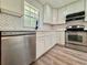 Kitchen featuring stainless steel appliances, a dishwasher, and white cabinets at 604 Ponderosa Dr, St Cloud, FL 34769