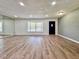 Bright living room featuring wood flooring, a large window and mirrors creating an open and airy space at 604 Ponderosa Dr, St Cloud, FL 34769