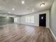 Bright living room featuring wood flooring, a large window and mirrors creating an open and airy space at 604 Ponderosa Dr, St Cloud, FL 34769