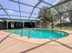 Screened-in pool featuring clear blue water, providing a relaxing outdoor space at 604 Ponderosa Dr, St Cloud, FL 34769