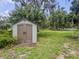 Well-maintained shed for extra storage space in a large backyard with mature trees and green grass at 604 Ponderosa Dr, St Cloud, FL 34769