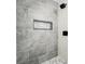 A modern shower featuring stylish gray tile, a built-in niche, and sleek fixtures at 604 Ponderosa Dr, St Cloud, FL 34769