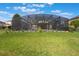 Spacious, green backyard features a screen-enclosed pool with manicured landscaping at 637 Neptune Dr, Groveland, FL 34736