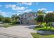 Attractive two-story home with a three-car garage, lush landscaping, and a spacious driveway at 637 Neptune Dr, Groveland, FL 34736