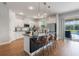 Bright kitchen featuring modern pendant lighting, white cabinets, stainless appliances, and access to the pool at 637 Neptune Dr, Groveland, FL 34736