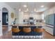 Bright kitchen featuring modern pendant lighting, white cabinets, stainless appliances, and counter seating at 637 Neptune Dr, Groveland, FL 34736