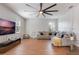 Cozy living room featuring wood-look floors, a modern ceiling fan, decorative trim, and comfortable seating at 637 Neptune Dr, Groveland, FL 34736