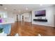 Spacious living area featuring wood-look floors, modern lighting, neutral walls, and ample space at 637 Neptune Dr, Groveland, FL 34736