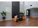 Open living space showcasing high ceilings, wood-look floors, modern black accents, and natural light at 637 Neptune Dr, Groveland, FL 34736