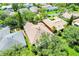 Aerial view of a single Gathering home with neutral roof and lush landscaping in a well-maintained community at 645 Highlands Hammock Dr, Kissimmee, FL 34759