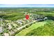 A planned community with an aerial view of a single-Gathering home featuring lush landscaping near a golf course at 645 Highlands Hammock Dr, Kissimmee, FL 34759