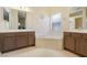 Large bathroom featuring double vanities, a soaking tub, and stylish fixtures at 645 Highlands Hammock Dr, Kissimmee, FL 34759