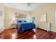 Inviting bedroom with hardwood floors, a large window, and neutral decor for a tranquil retreat at 645 Highlands Hammock Dr, Kissimmee, FL 34759