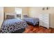Comfortable bedroom featuring twin beds, wood floors, and neutral paint at 645 Highlands Hammock Dr, Kissimmee, FL 34759