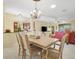 Open dining area with a chandelier and views into the kitchen and living room at 645 Highlands Hammock Dr, Kissimmee, FL 34759