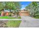 Charming single-Gathering home with a two car garage, brick paver driveway and meticulous landscaping at 645 Highlands Hammock Dr, Kissimmee, FL 34759