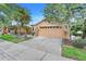 Charming single-Gathering home featuring a two-car garage, a brick paver driveway, and meticulously maintained landscaping at 645 Highlands Hammock Dr, Kissimmee, FL 34759