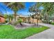 Well-maintained single-story home with a lush green lawn and mature landscaping at 645 Highlands Hammock Dr, Kissimmee, FL 34759