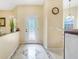Bright foyer with decorative tile flooring, an ornate glass front door and a decorative clock at 645 Highlands Hammock Dr, Kissimmee, FL 34759