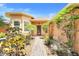 Charming front entrance with brick pathway, flowering plants, and a peach stucco home at 645 Highlands Hammock Dr, Kissimmee, FL 34759