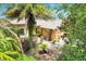 A charming single-Gathering home with lush landscaping, mature palms, and a brick paved walkway at 645 Highlands Hammock Dr, Kissimmee, FL 34759