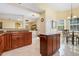 Open kitchen with granite counters, wood cabinets, and views into the breakfast nook at 645 Highlands Hammock Dr, Kissimmee, FL 34759