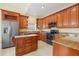 Elegant kitchen boasts custom wood cabinets, granite counters, and a convenient center island at 645 Highlands Hammock Dr, Kissimmee, FL 34759
