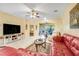 Spacious living room with tile flooring, ceiling fan and access to sunroom at 645 Highlands Hammock Dr, Kissimmee, FL 34759