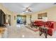 Bright living room with tile flooring, ceiling fan and large arched doorways at 645 Highlands Hammock Dr, Kissimmee, FL 34759