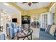 Bright living room featuring tile floors and glass doors, creating a seamless flow to the outdoors at 645 Highlands Hammock Dr, Kissimmee, FL 34759