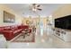 Open living room with tile floors, ceiling fan, and a view of the dining area at 645 Highlands Hammock Dr, Kissimmee, FL 34759