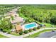 Aerial view of community pool and patio area surrounded by lush landscaping and mature trees at 645 Highlands Hammock Dr, Kissimmee, FL 34759
