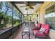 Relaxing screened porch with ceiling fans and wicker seating, perfect for outdoor lounging at 645 Highlands Hammock Dr, Kissimmee, FL 34759