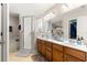 Bright bathroom featuring a dual sink vanity, glass shower, and lots of counter space at 70 Locust Pass Run, Ocala, FL 34472