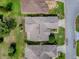 Bird's eye view of property showing roof, landscaping, and surrounding neighborhood at 712 Old Oaks Ln, Leesburg, FL 34748