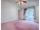 Bright main bedroom with sliding door access to an outdoor patio at 712 Old Oaks Ln, Leesburg, FL 34748