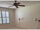 Spacious bedroom with plush carpet, a ceiling fan, and a large window with plantation shutters at 724 Rosemere Cir, Orlando, FL 32835