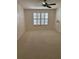 Bright bedroom featuring neutral carpet, ceiling fan, and window with plantation shutters at 724 Rosemere Cir, Orlando, FL 32835