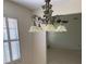 Dining area highlighting a decorative chandelier, shutters, and neutral walls at 724 Rosemere Cir, Orlando, FL 32835
