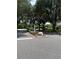 Landscaped community entrance with mature trees, lush greenery, and a stone accent that welcomes you home at 724 Rosemere Cir, Orlando, FL 32835