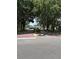 Beautiful community entrance featuring mature trees, brick paving, and welcoming landscaping at 724 Rosemere Cir, Orlando, FL 32835