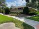 Entrance to Lake Rose Pointe featuring meticulous landscaping and mature shrubbery around the sign at 724 Rosemere Cir, Orlando, FL 32835