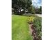 Beautiful front yard featuring mature trees and lush landscaping at 724 Rosemere Cir, Orlando, FL 32835