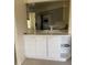 Bright kitchen featuring white cabinets, modern appliances, and a view to the dining area at 724 Rosemere Cir, Orlando, FL 32835