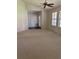Open living room featuring a ceiling fan, neutral carpet and a front door at 724 Rosemere Cir, Orlando, FL 32835