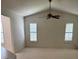 Bright living room with vaulted ceilings, carpeted floors, and multiple windows at 724 Rosemere Cir, Orlando, FL 32835