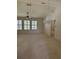 Spacious living room with high ceilings, chandelier, and shuttered windows at 724 Rosemere Cir, Orlando, FL 32835